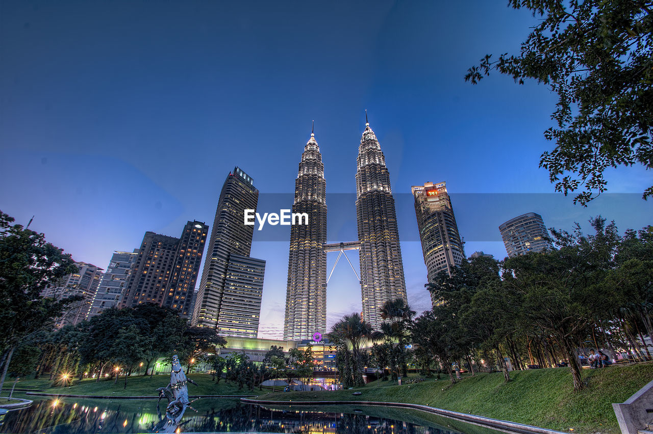 Low angle view of skyscrapers lit up at night