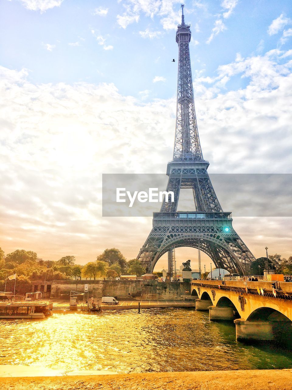 Eiffel tower against cloudy sky