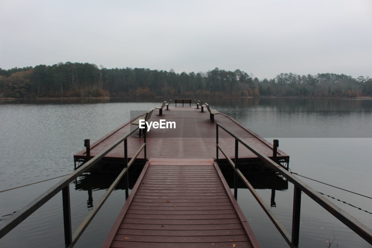 Pier on lake against clear sky