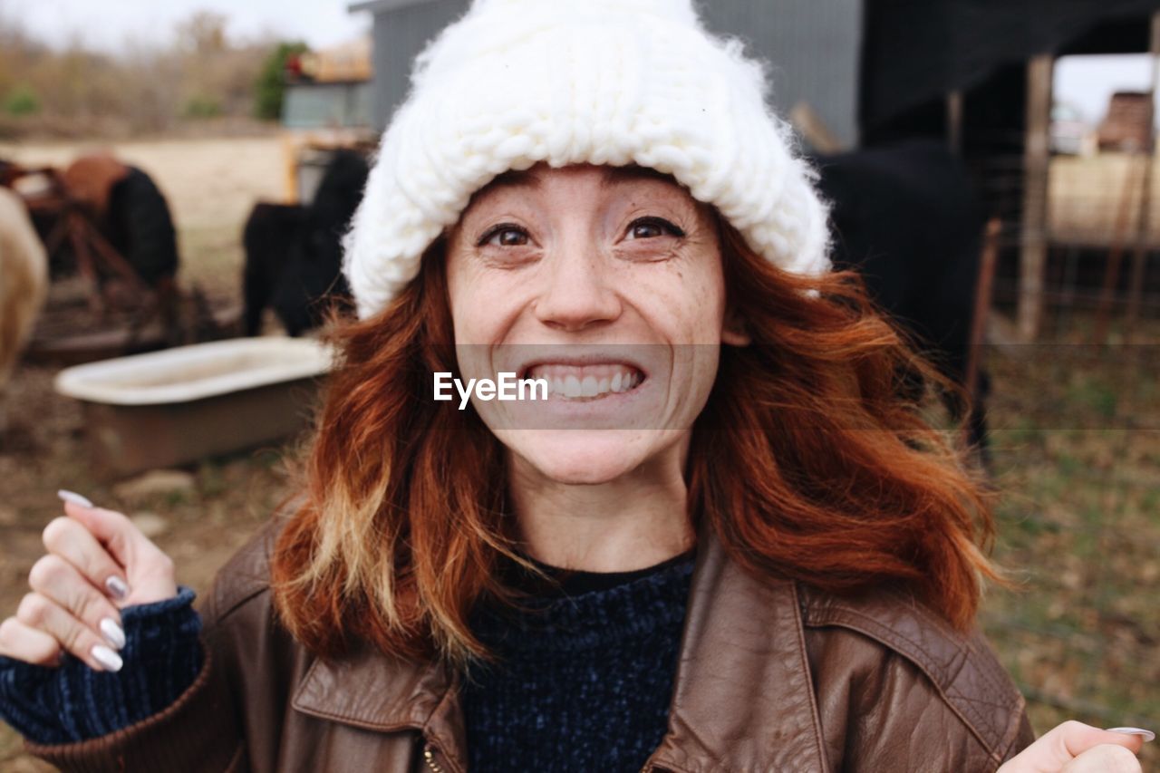 Portrait of smiling mature woman wearing warm clothing at farm