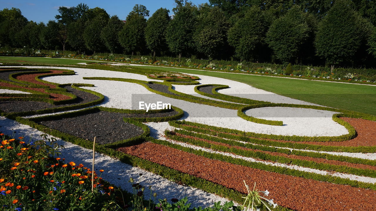 VIEW OF FORMAL GARDEN WITH PARK IN BACKGROUND