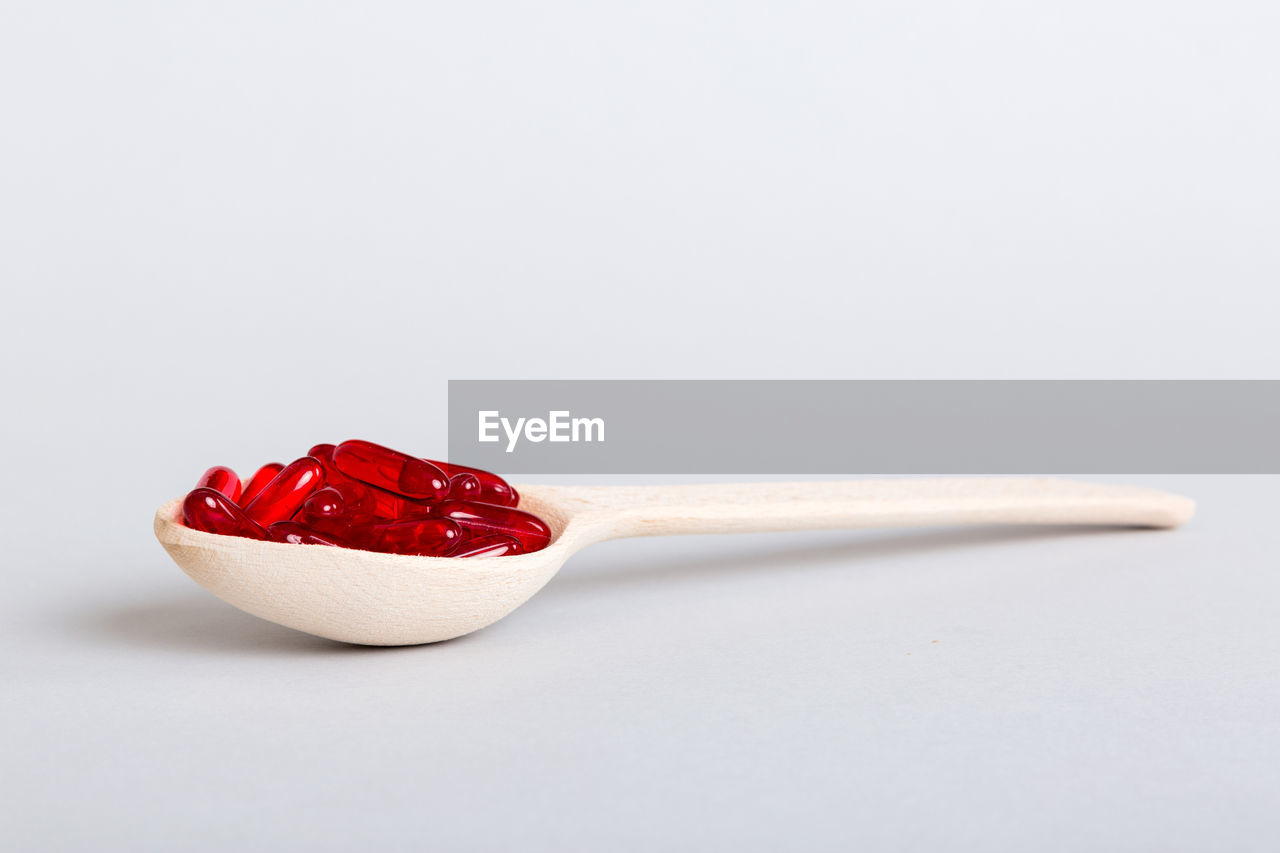 food, food and drink, studio shot, healthy eating, spoon, red, fruit, white background, indoors, kitchen utensil, eating utensil, wellbeing, sweet food, freshness, sweet, produce, no people, dessert, copy space, cut out, berry, strawberry, single object, close-up