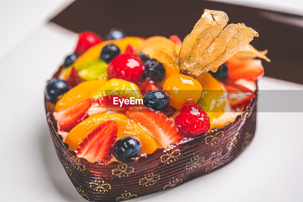 CLOSE-UP OF FRUITS IN PLATE WITH FORK