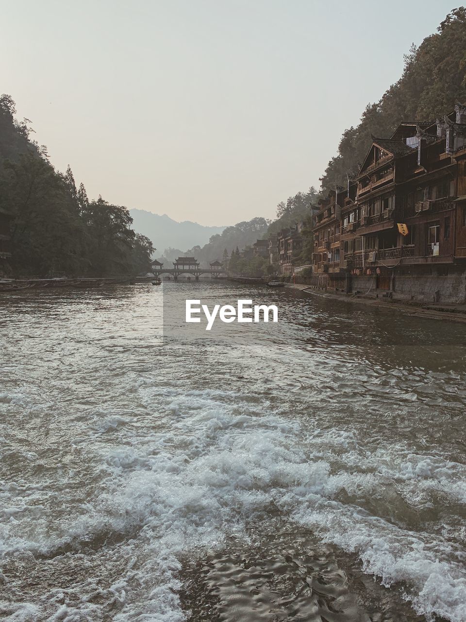 SCENIC VIEW OF RIVER AND BUILDINGS AGAINST SKY