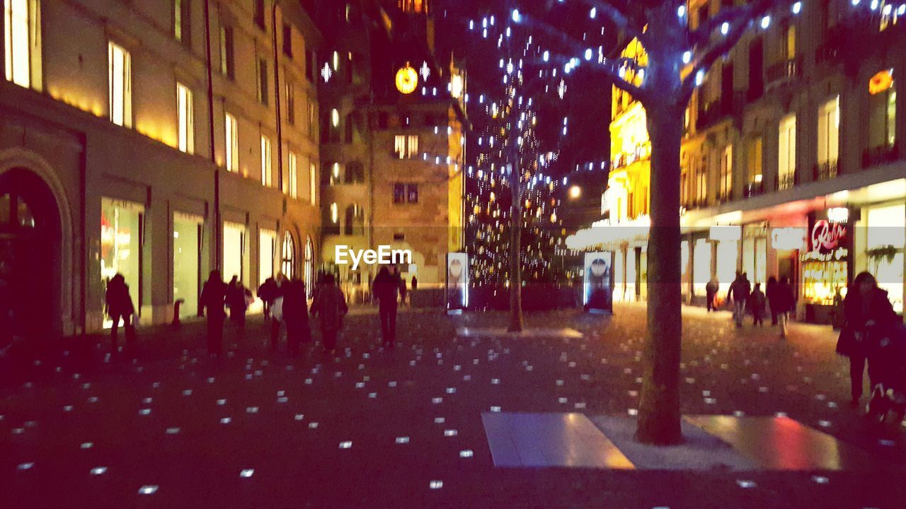 VIEW OF PEOPLE IN ILLUMINATED ROOM