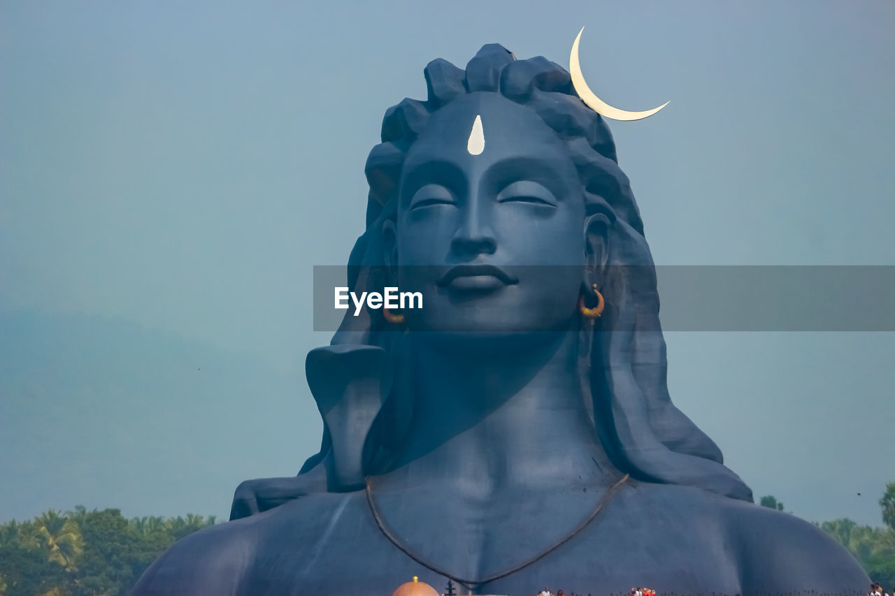 CLOSE-UP OF STATUE AGAINST CLEAR BLUE SKY