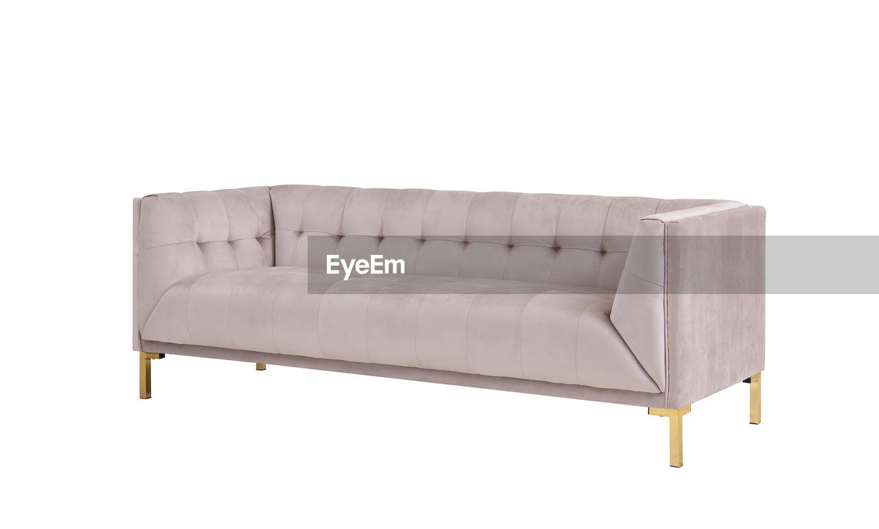 CLOSE-UP OF SOFA AGAINST WHITE BACKGROUND