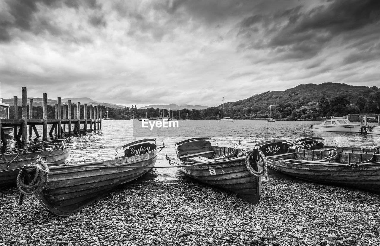 BOATS MOORED AT HARBOR