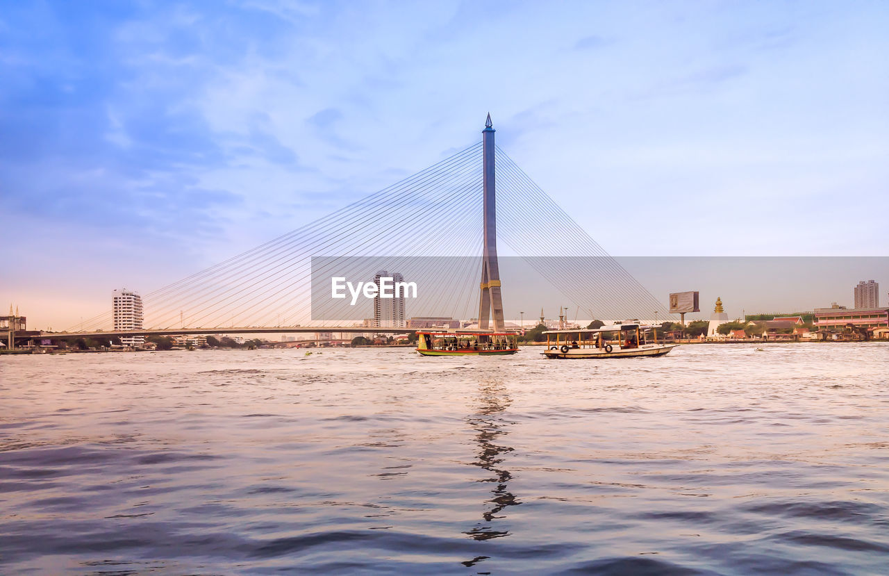 View of suspension bridge with city in background