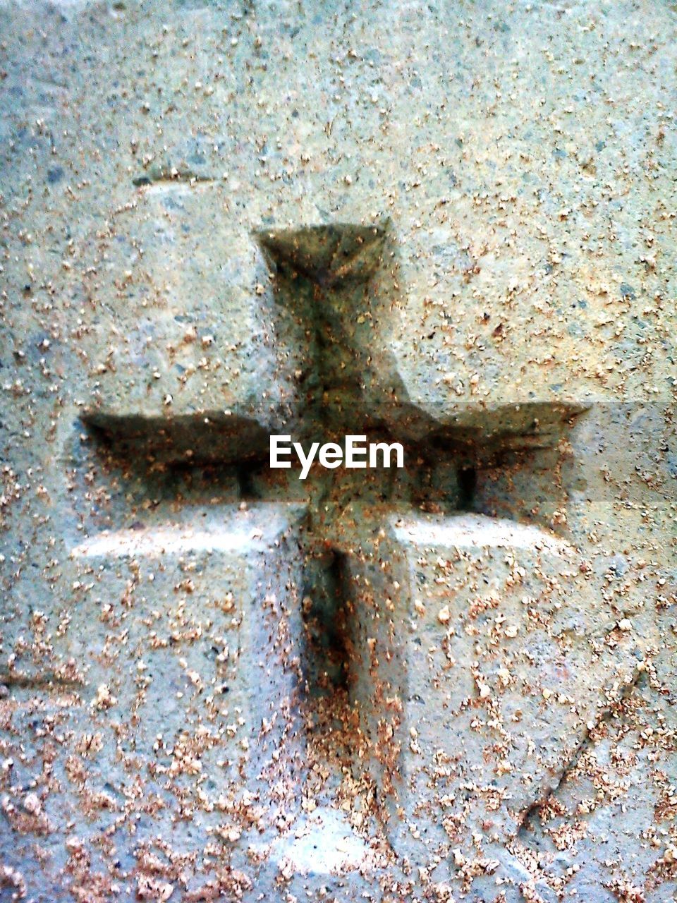 Close-up of cross sign on wall