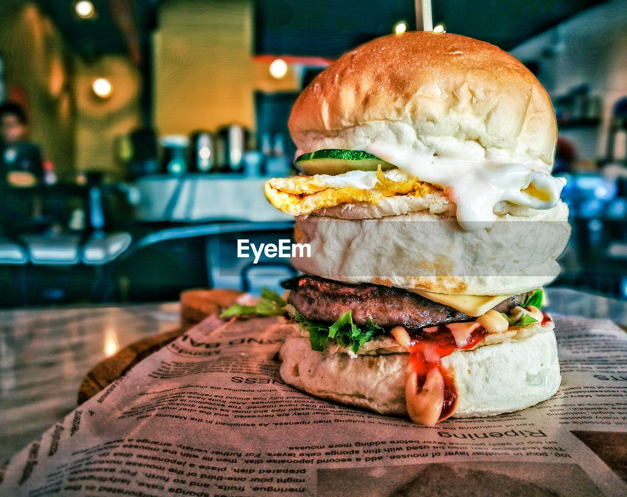 Close-up of burger on paper at restaurant