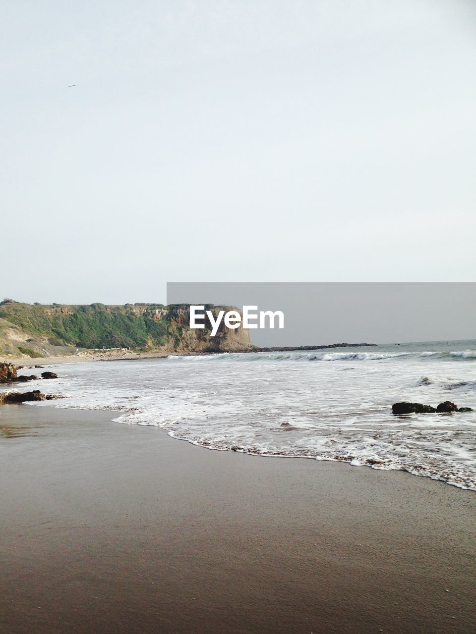 Scenic view of beach against clear sky