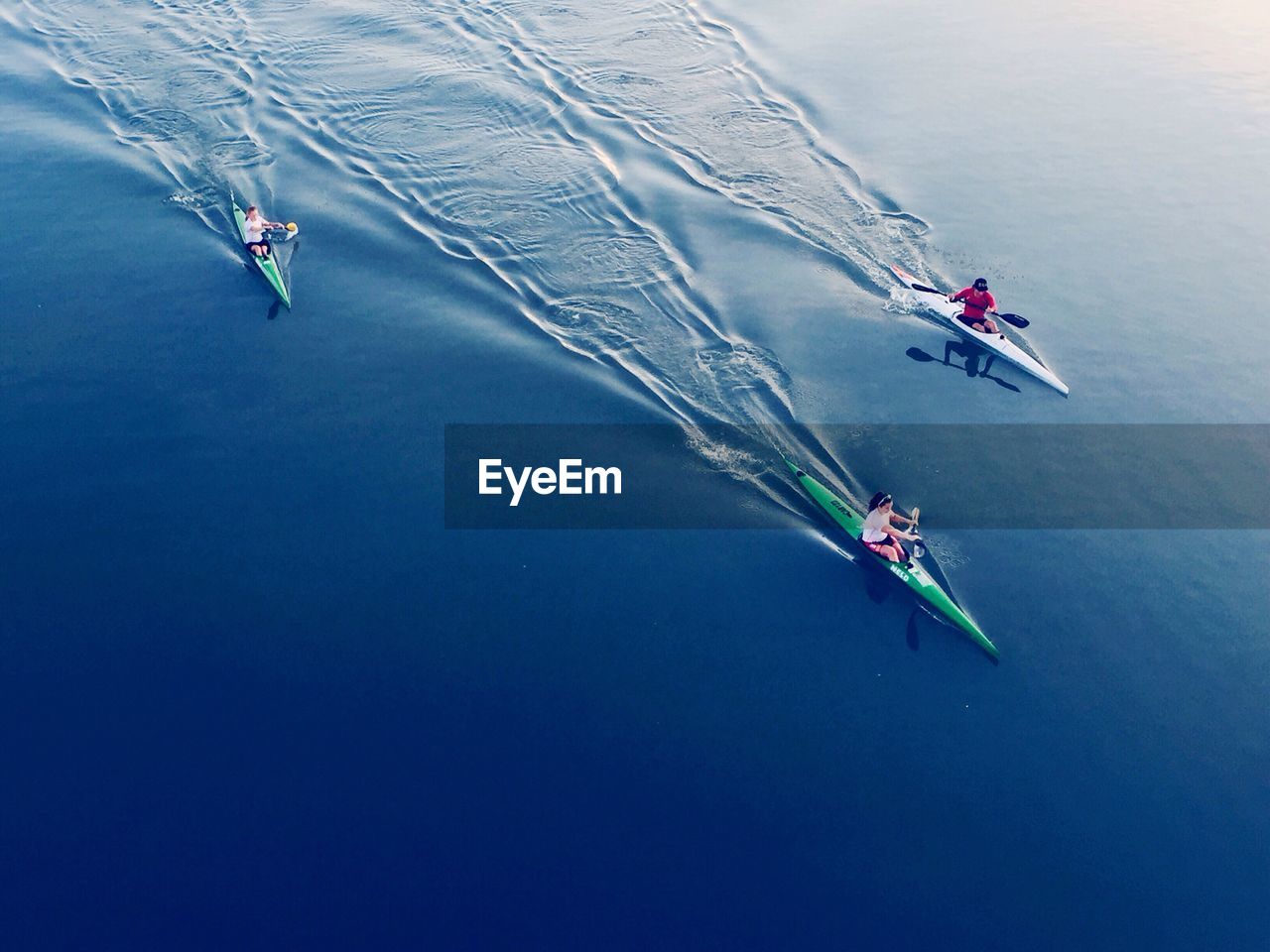 High angle view of people kayaking in sea
