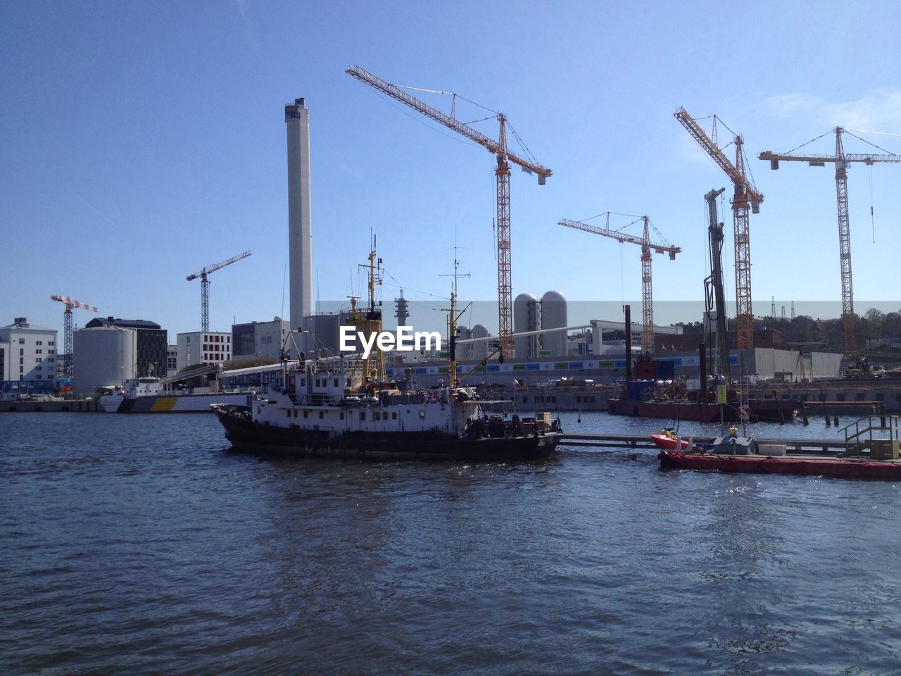 Commercial dock in sea against clear sky