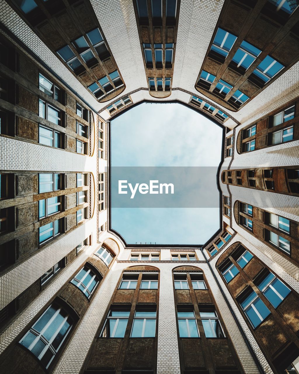 Directly below shot of buildings against sky