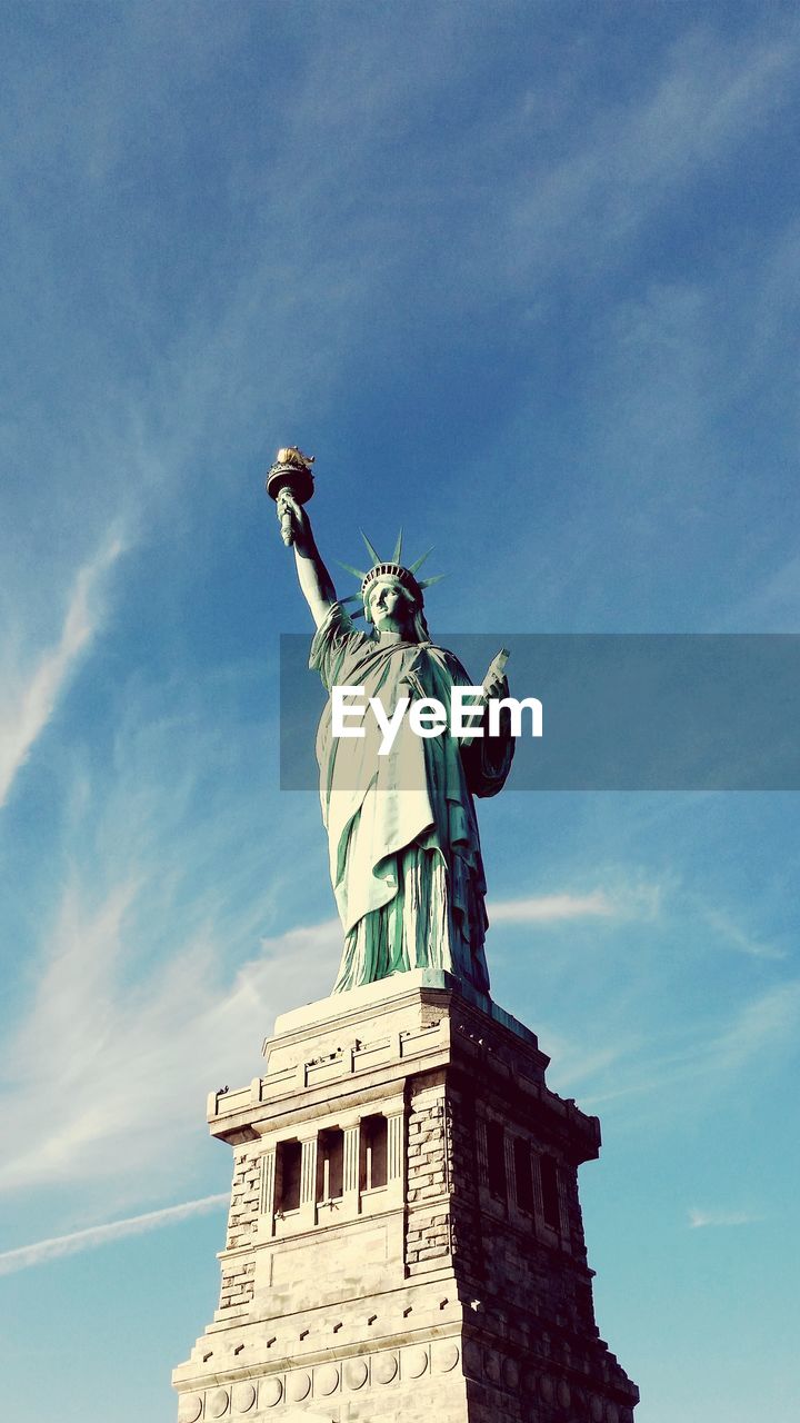 Low angle view of statue against cloudy sky