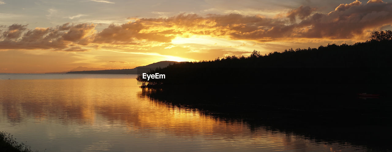 Scenic view of lake against sky during sunset