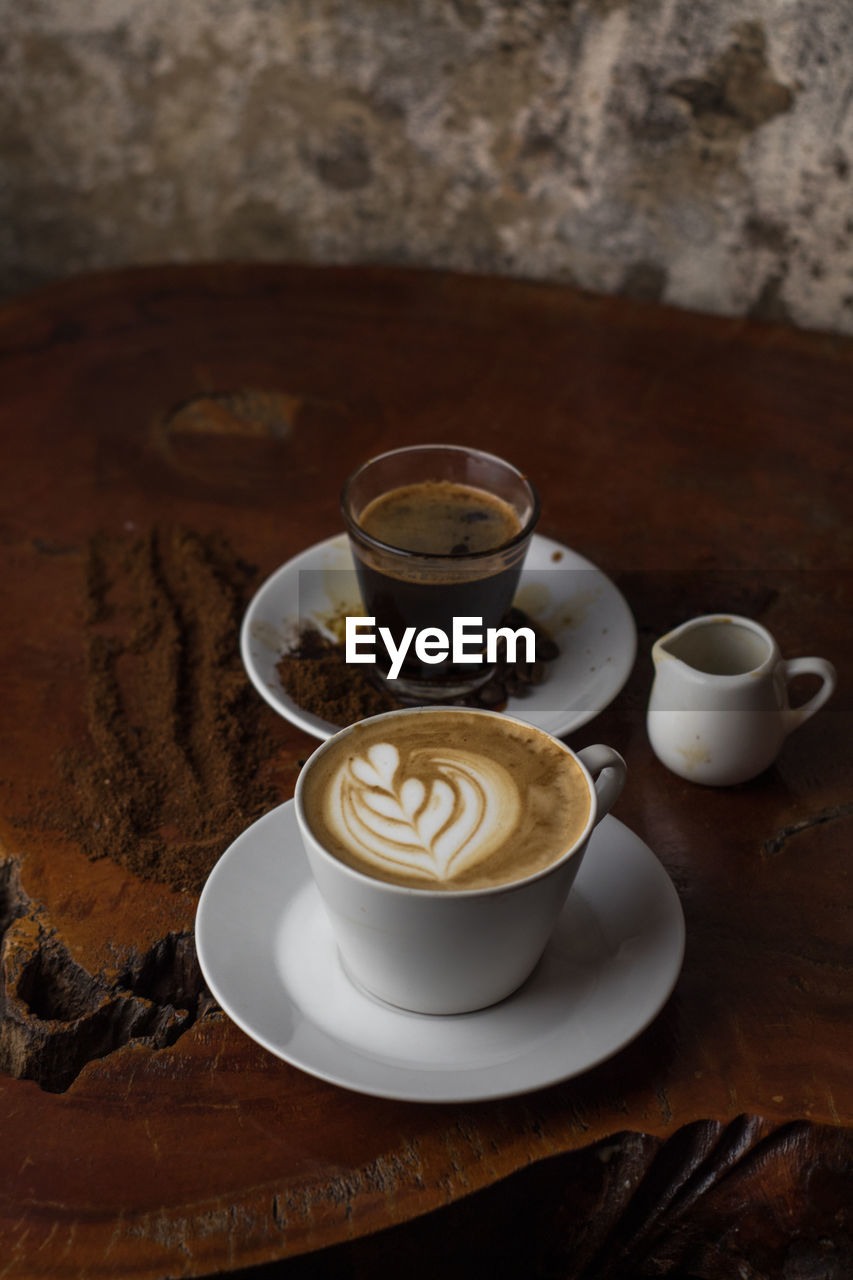 COFFEE CUP WITH TEA ON TABLE