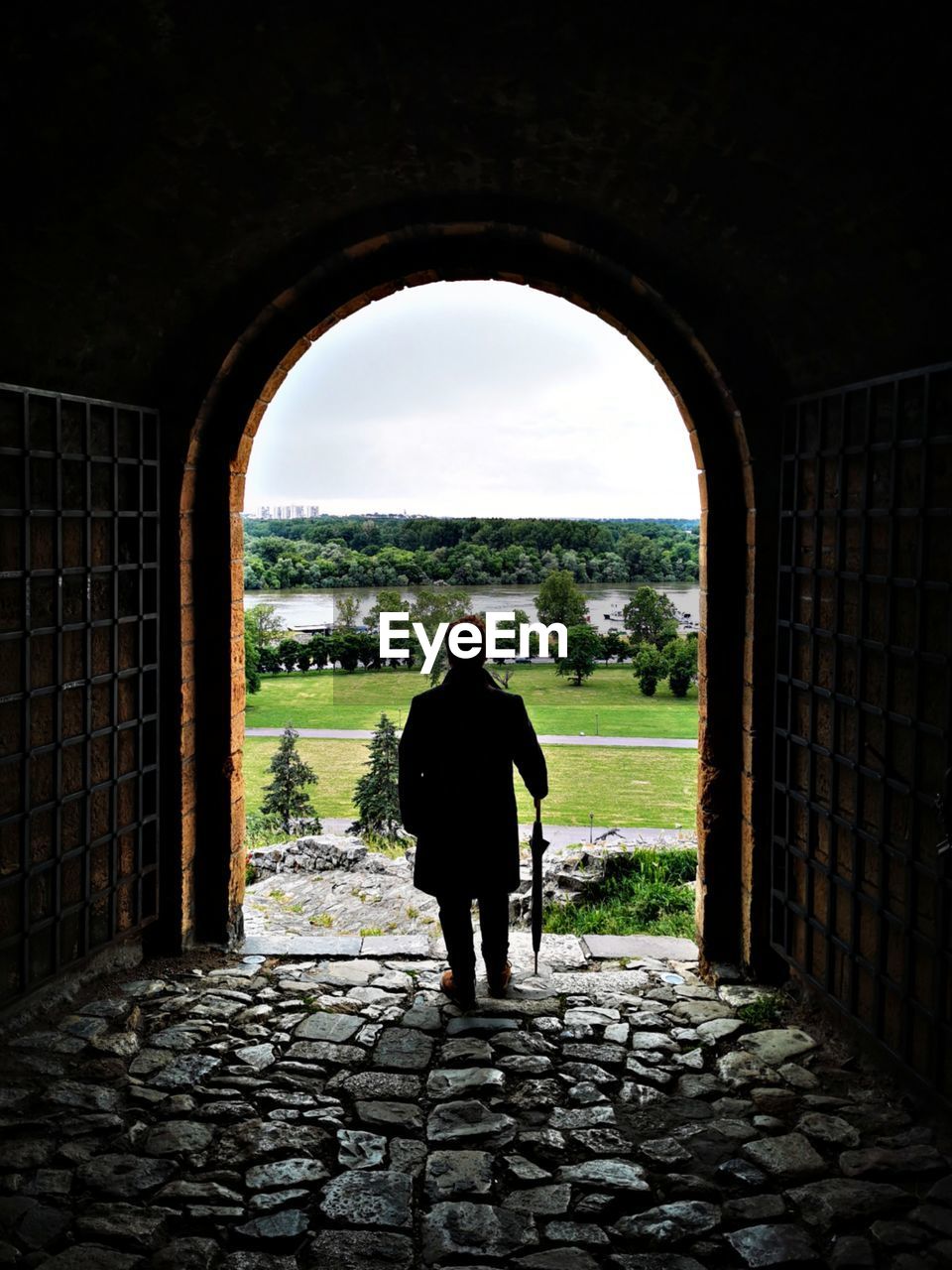 Rear view of man standing on the fortress, looking at the landscape. 