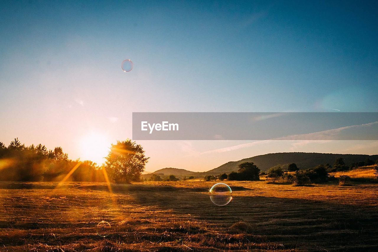 VIEW OF HOT AIR BALLOON FLYING OVER LAND