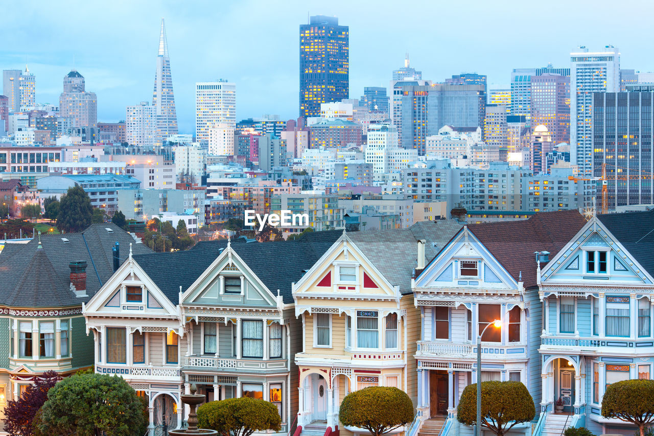 Traditional victorian houses at alamo square and downtown skyline, san francisco, california, usa