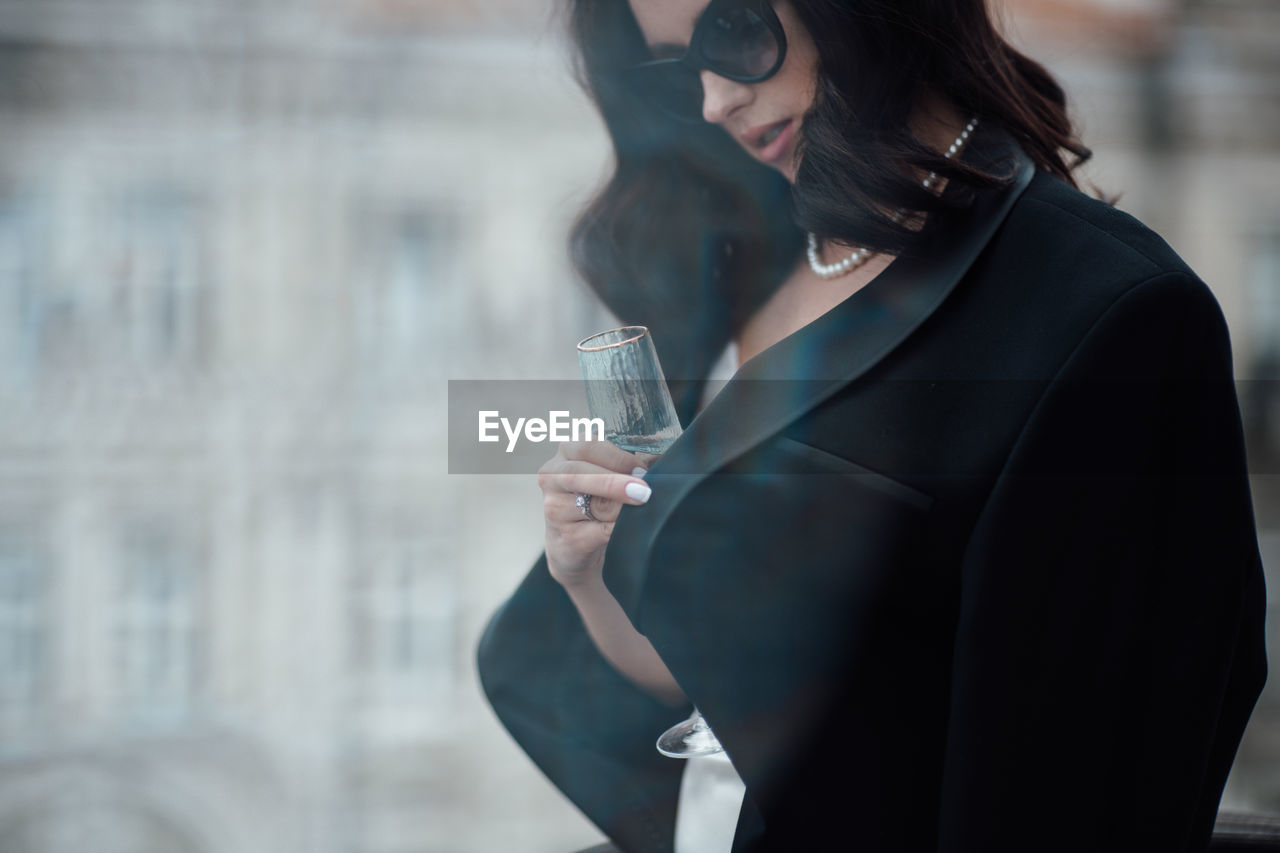 Midsection of a woman drinking glass