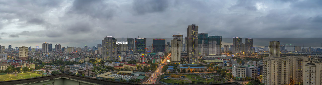 Panoramic view of buildings in city against sky