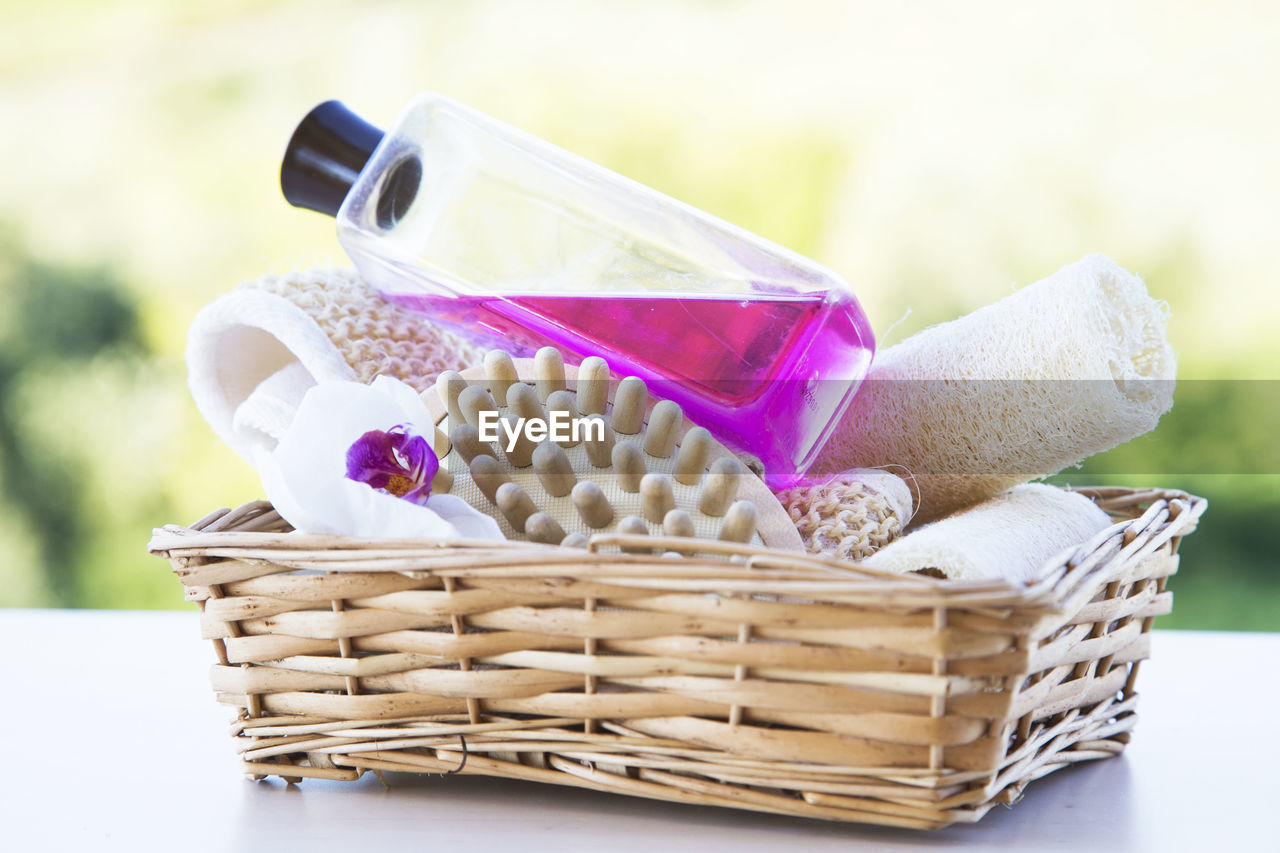 CLOSE-UP OF WICKER BASKET WITH BOTTLE