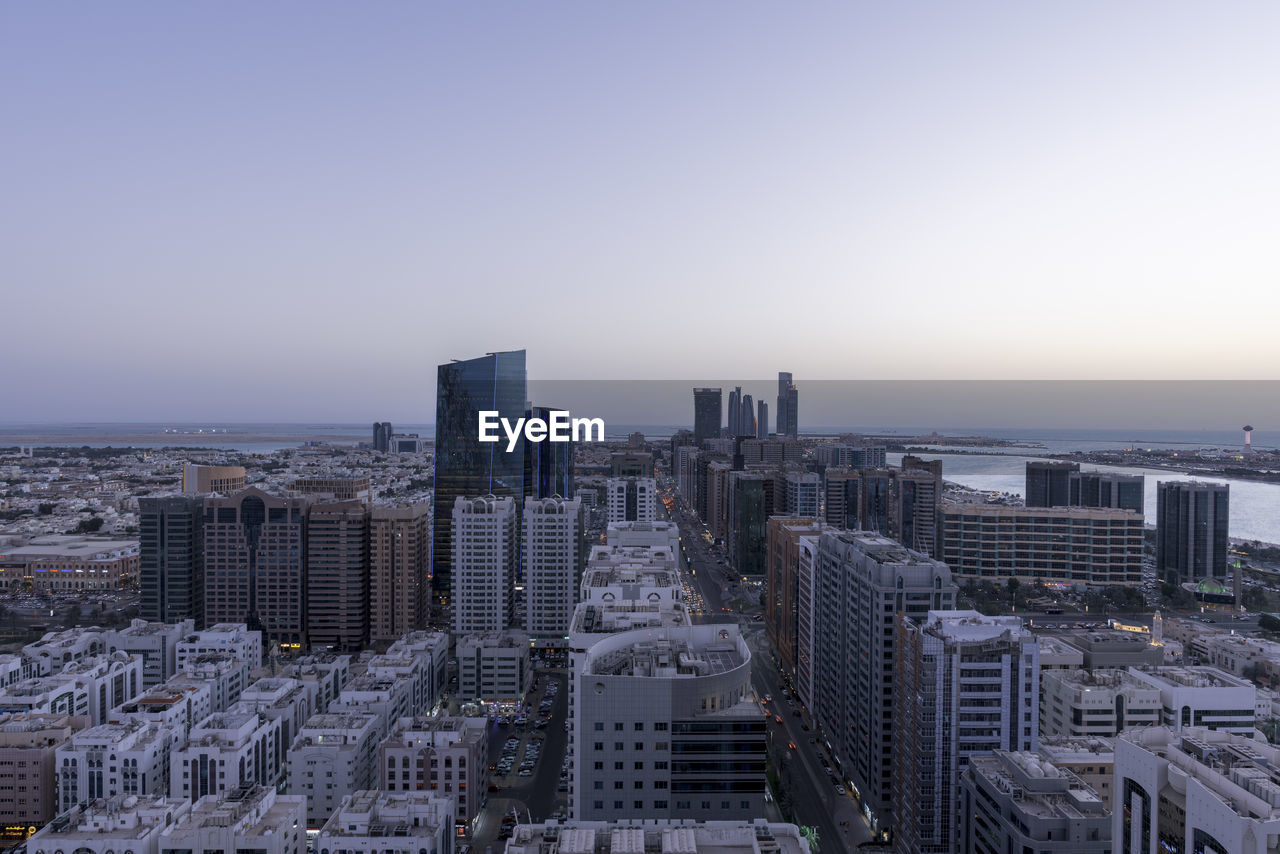 MODERN BUILDINGS IN CITY AGAINST CLEAR SKY