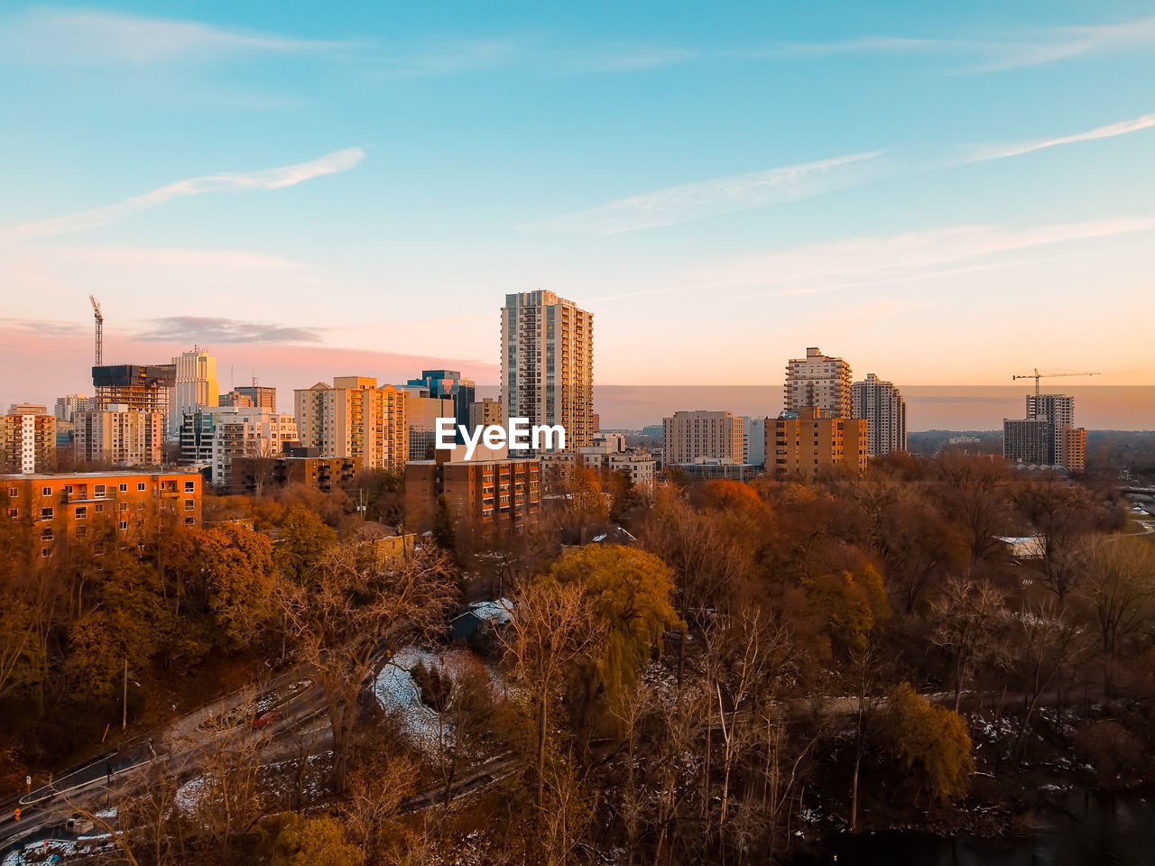 MODERN BUILDINGS AGAINST SKY DURING SUNSET