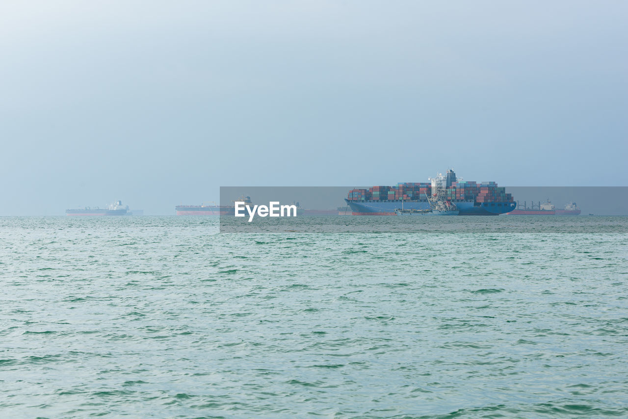 NAUTICAL VESSEL SAILING IN SEA AGAINST SKY