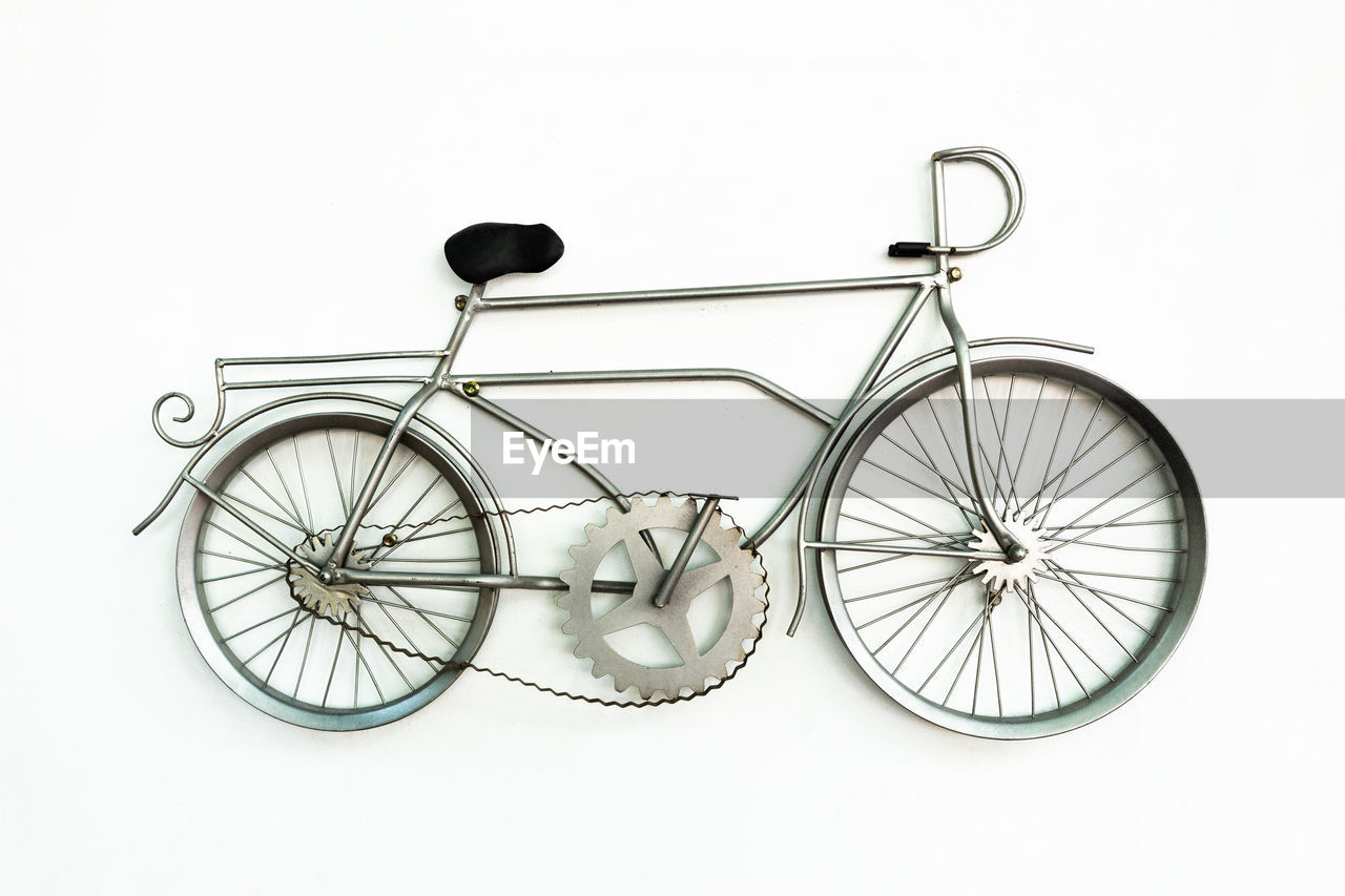 Close-up of toy bicycle against white background