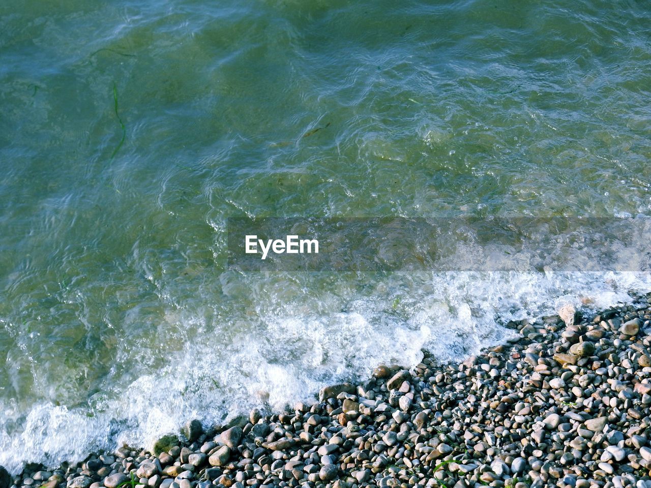 High angle view of waves reaching on shore