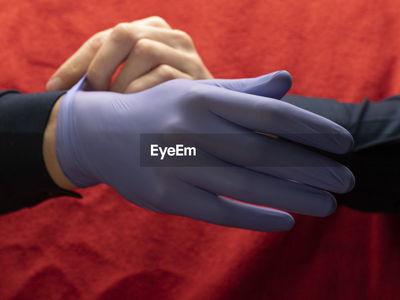Midsection of man wearing gloves