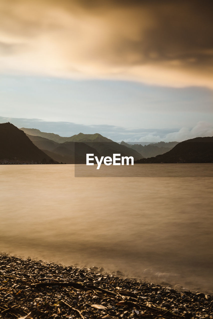 Scenic view of lake against cloudy sky