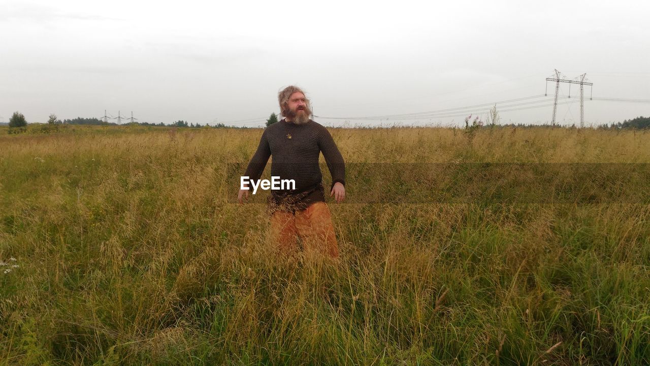 FULL LENGTH OF MAN STANDING ON FIELD