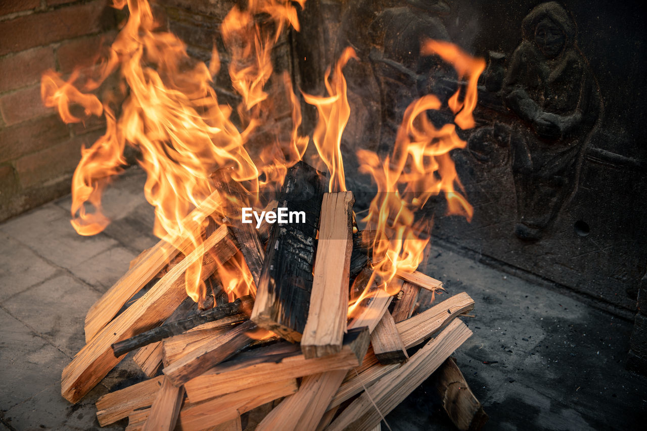 Pyre of burning wood with flames. charcoal for grilling meat. wood logs burn in the fireplace