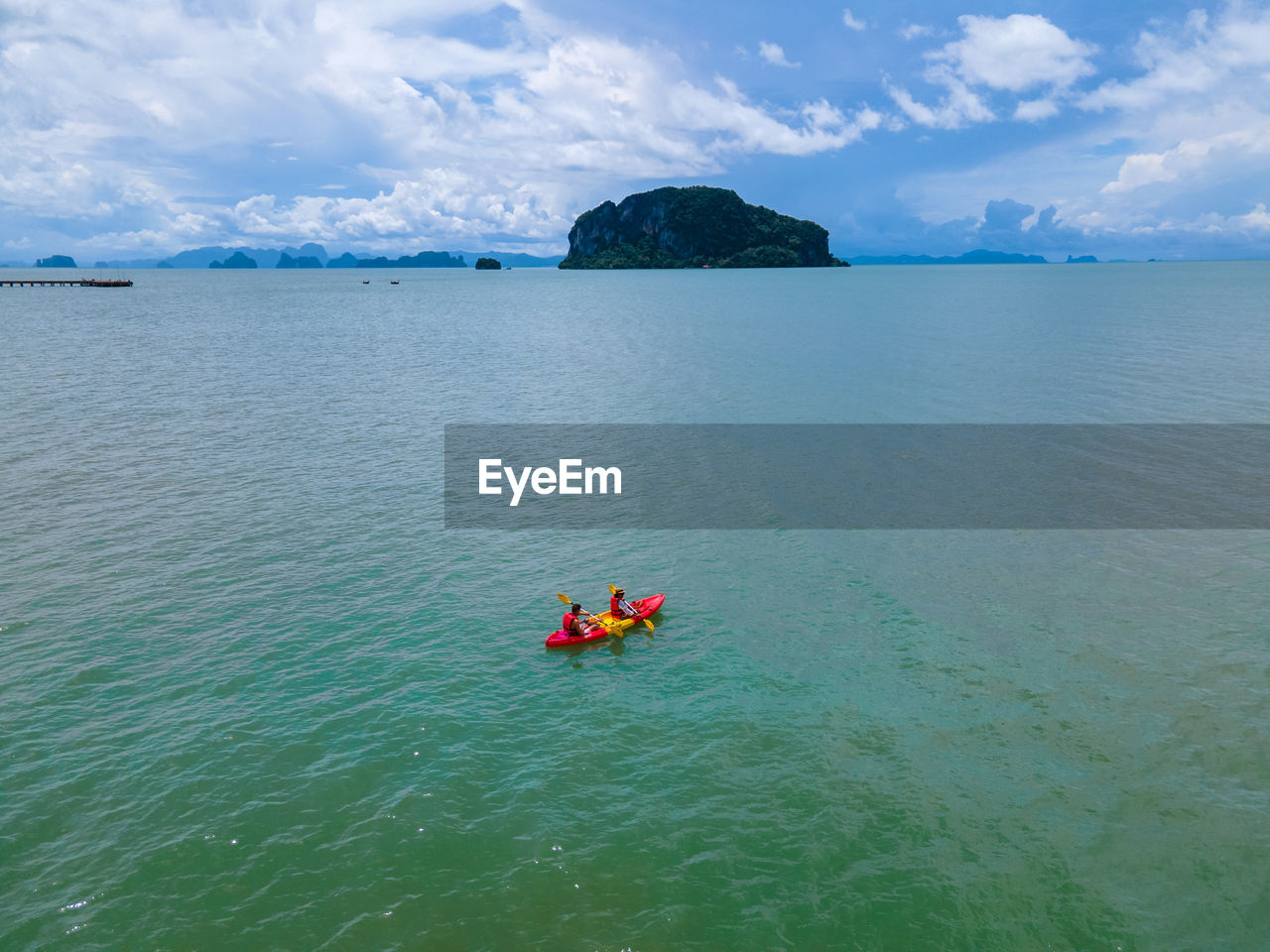 high angle view of people kayaking in sea against sky