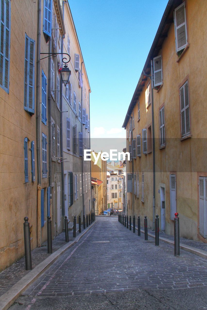 Street amidst buildings against sky