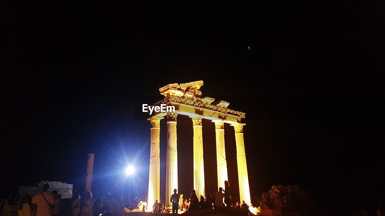 LOW ANGLE VIEW OF ILLUMINATED BUILDING AGAINST SKY