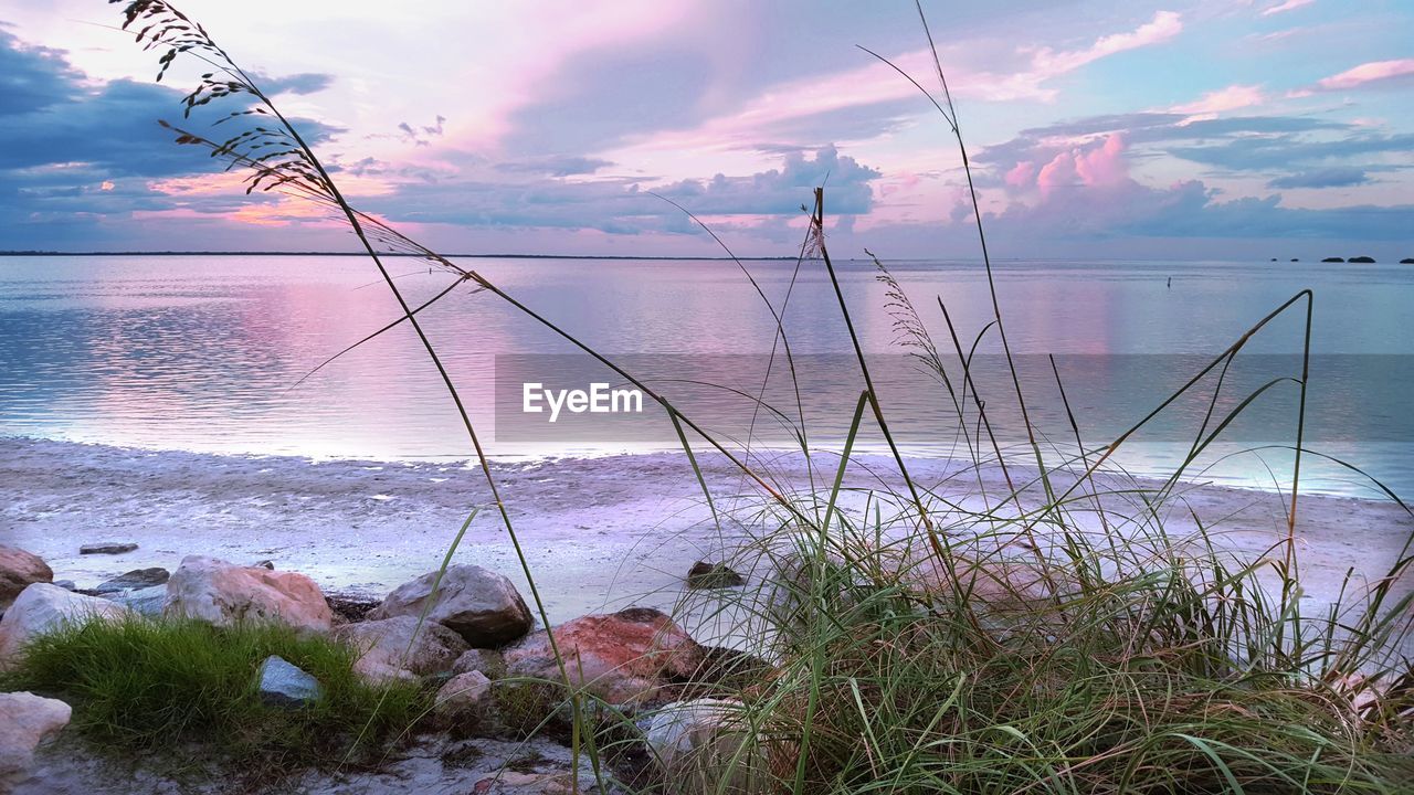 Scenic view of sea against cloudy sky