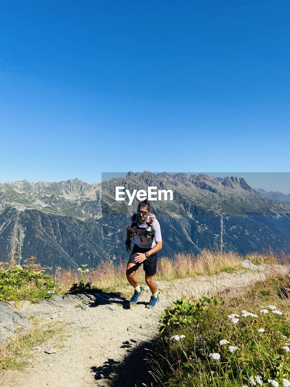 Full length of man standing on mountain against clear sky