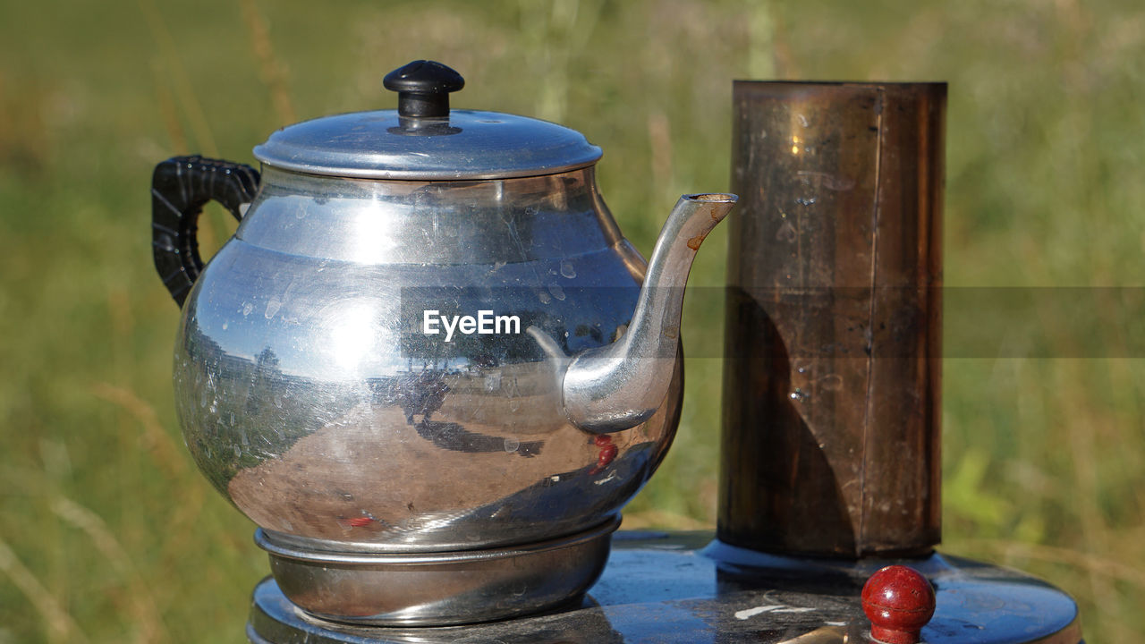 metal, teapot, kettle, household equipment, no people, silver, food and drink, nature, close-up, art, iron, drink, wood, kitchen utensil, focus on foreground, outdoors, container