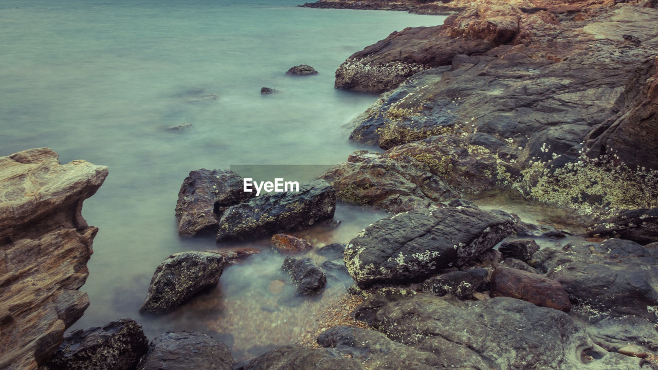 ROCKS AT SEA SHORE