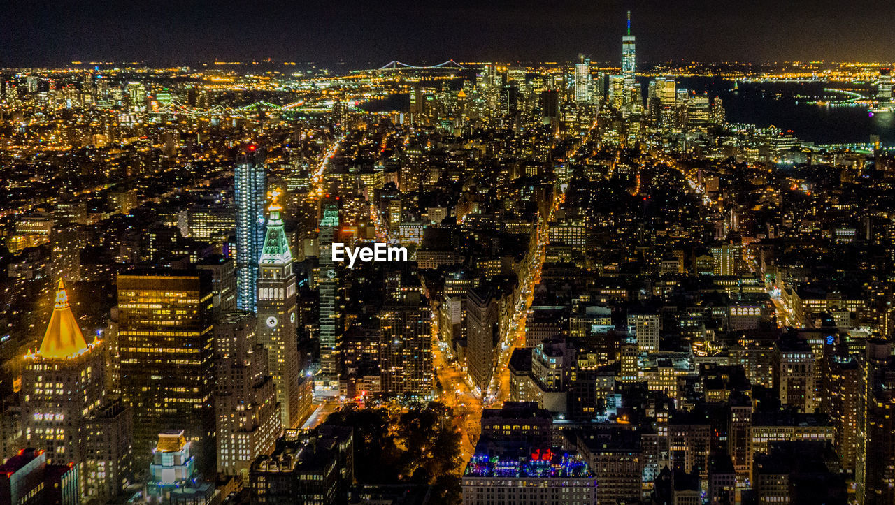 High angle view of city lit up at night