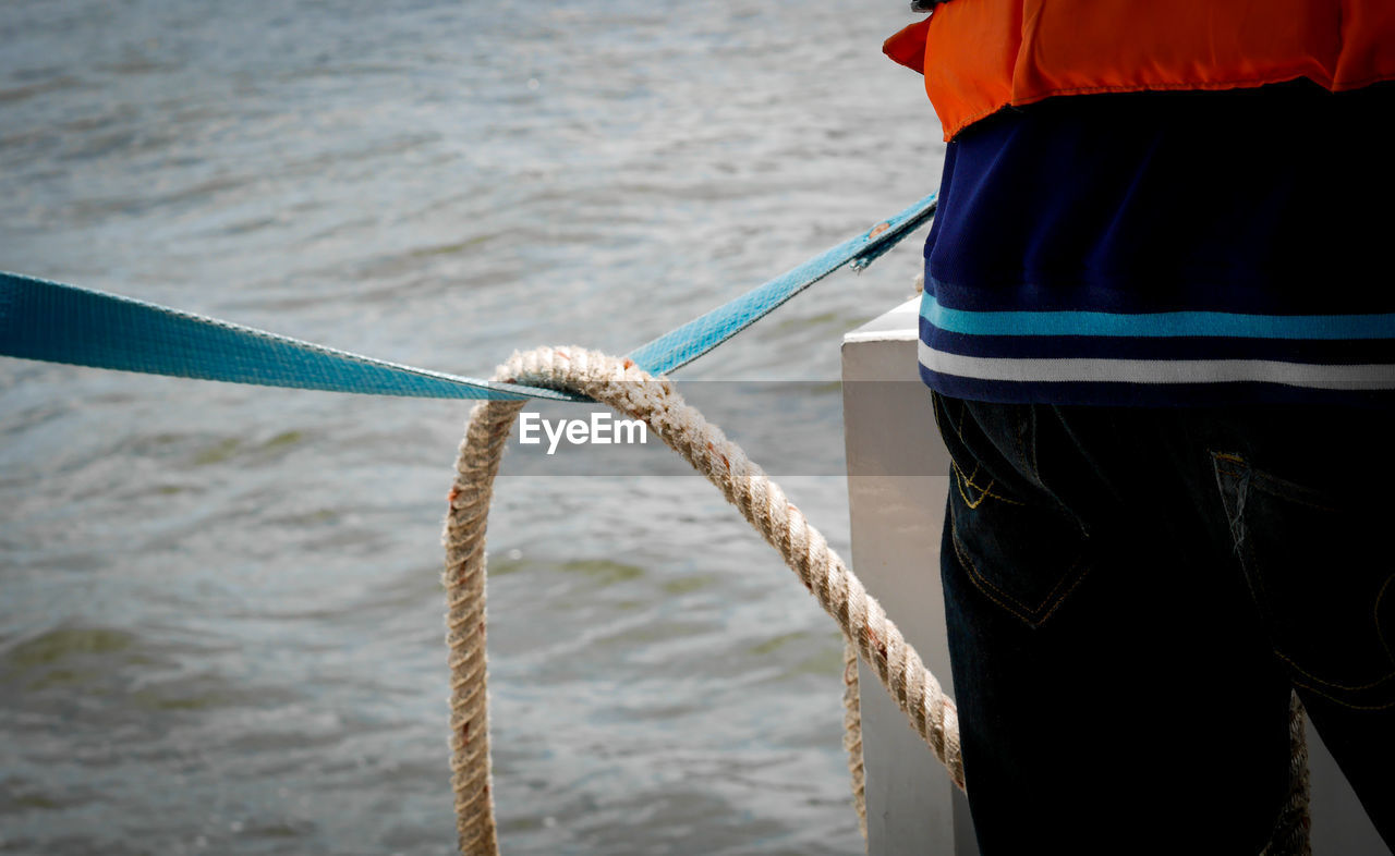 Midsection of person standing on ship