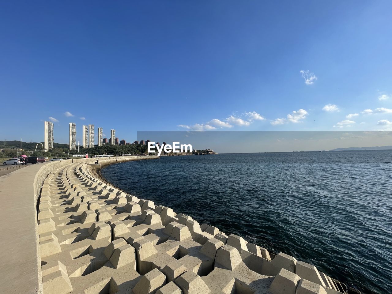 horizon, sky, water, sea, architecture, shore, coast, nature, blue, built structure, ocean, beach, city, travel destinations, building exterior, land, clear sky, travel, sunlight, bay, sunny, scenics - nature, outdoors, urban skyline, day, no people, beauty in nature, tower, landscape, tourism, breakwater, building, transportation, environment, cloud, copy space, tranquility, walkway, horizon over water, body of water, vacation