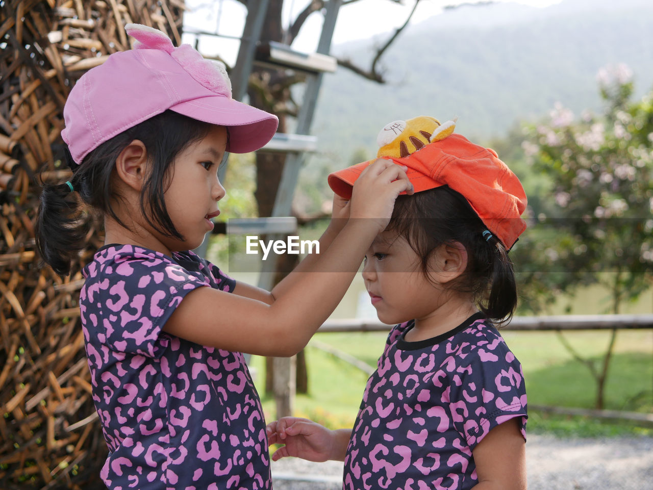 Portrait of girls wearing cap standing outdoors