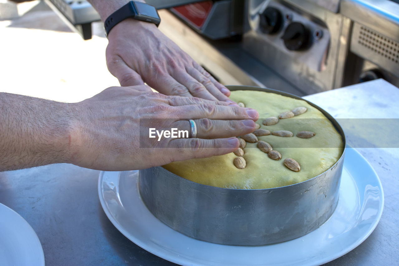 Cropped hand of man preparing food