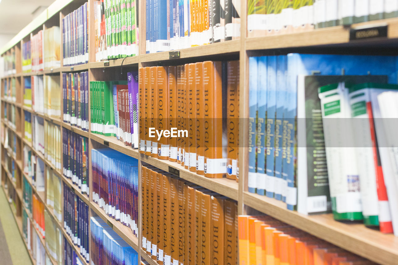 MULTI COLORED BOOKS IN SHELF